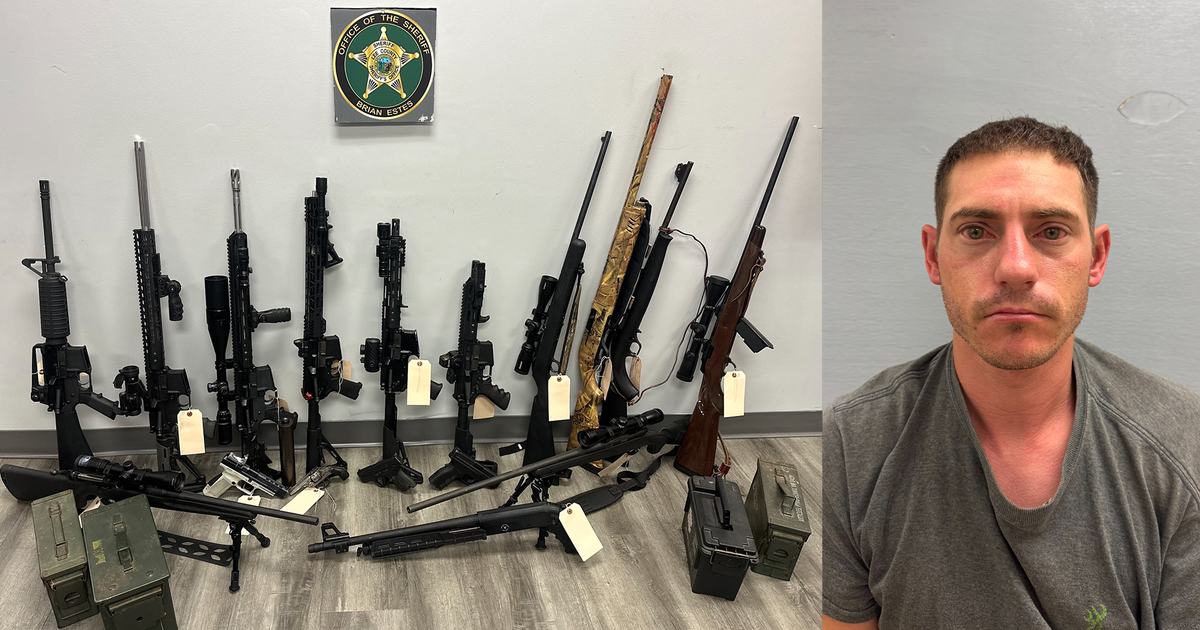Man charged with hiding firearms in secret room behind bookshelf ...