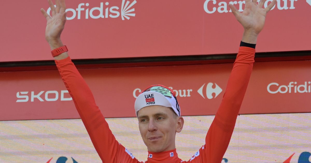 Slovenia's Tadej Pogacar, wearing the overall leader's red jersey celebrates on the podium after the second stage of the La