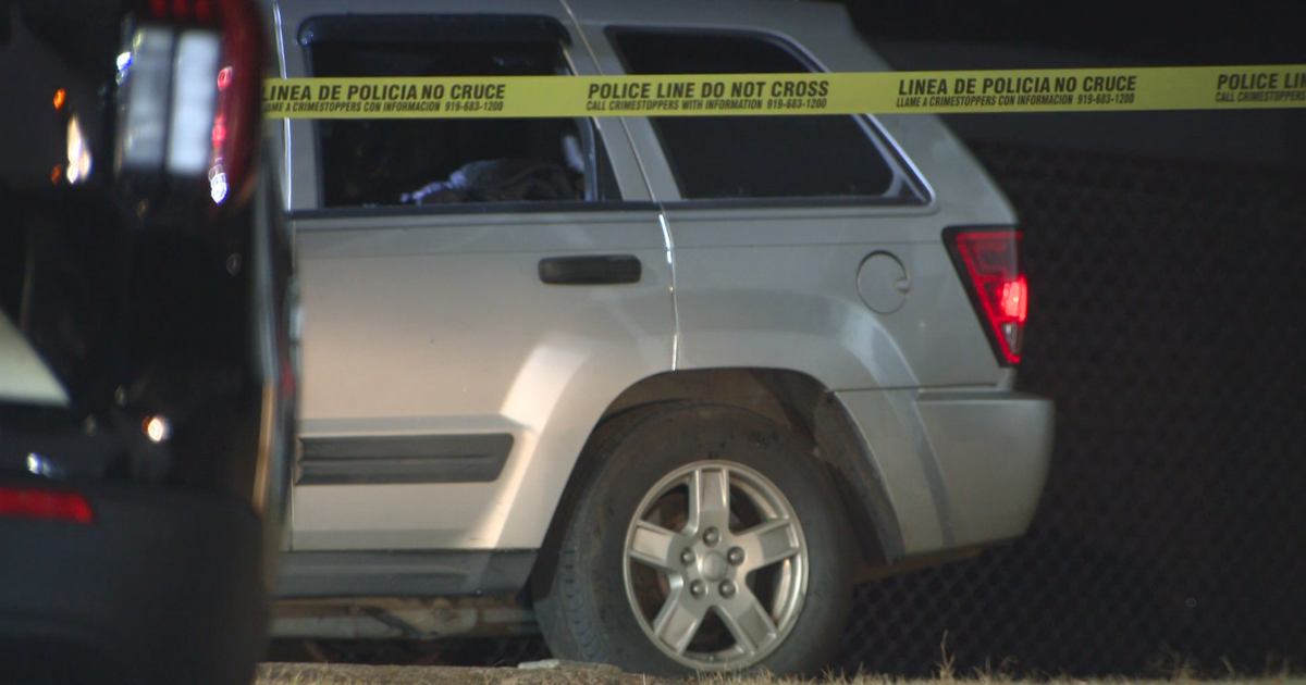 Durham police investigate cause of death for person found in burned car parked in driveway