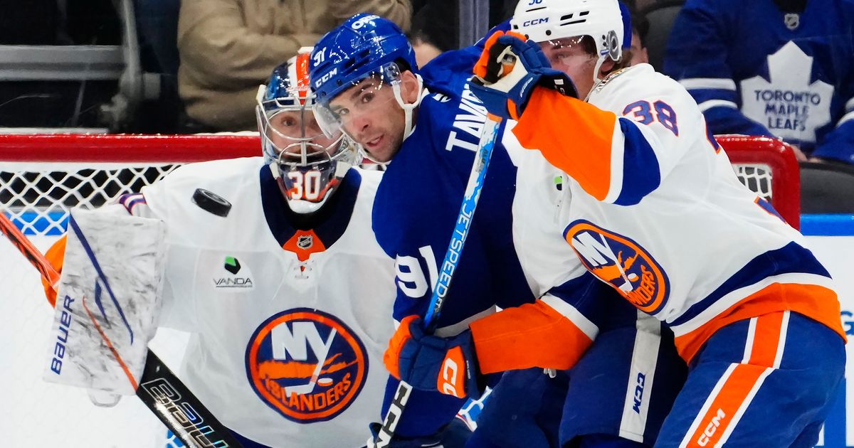 New York Islanders goaltender Ilya Sorokin (30) watches the puck as Toronto Maple Leafs' John Tavares (91) battles with