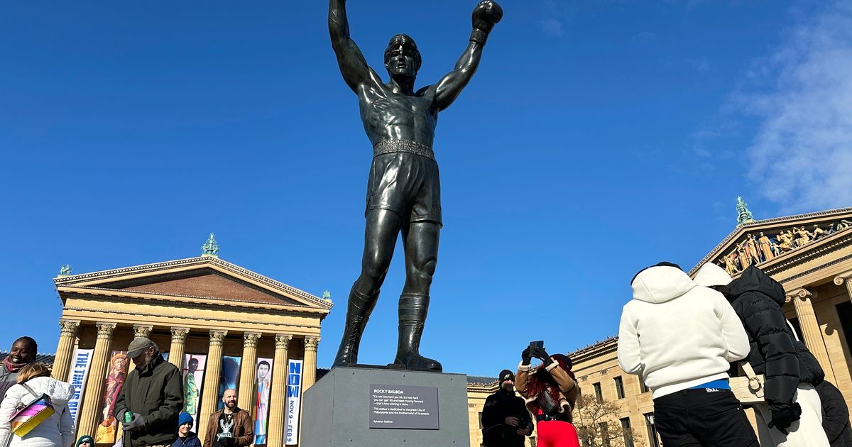 Brazilian soccer fans at the World Cup heed warning not to dress Rocky statue in team gear