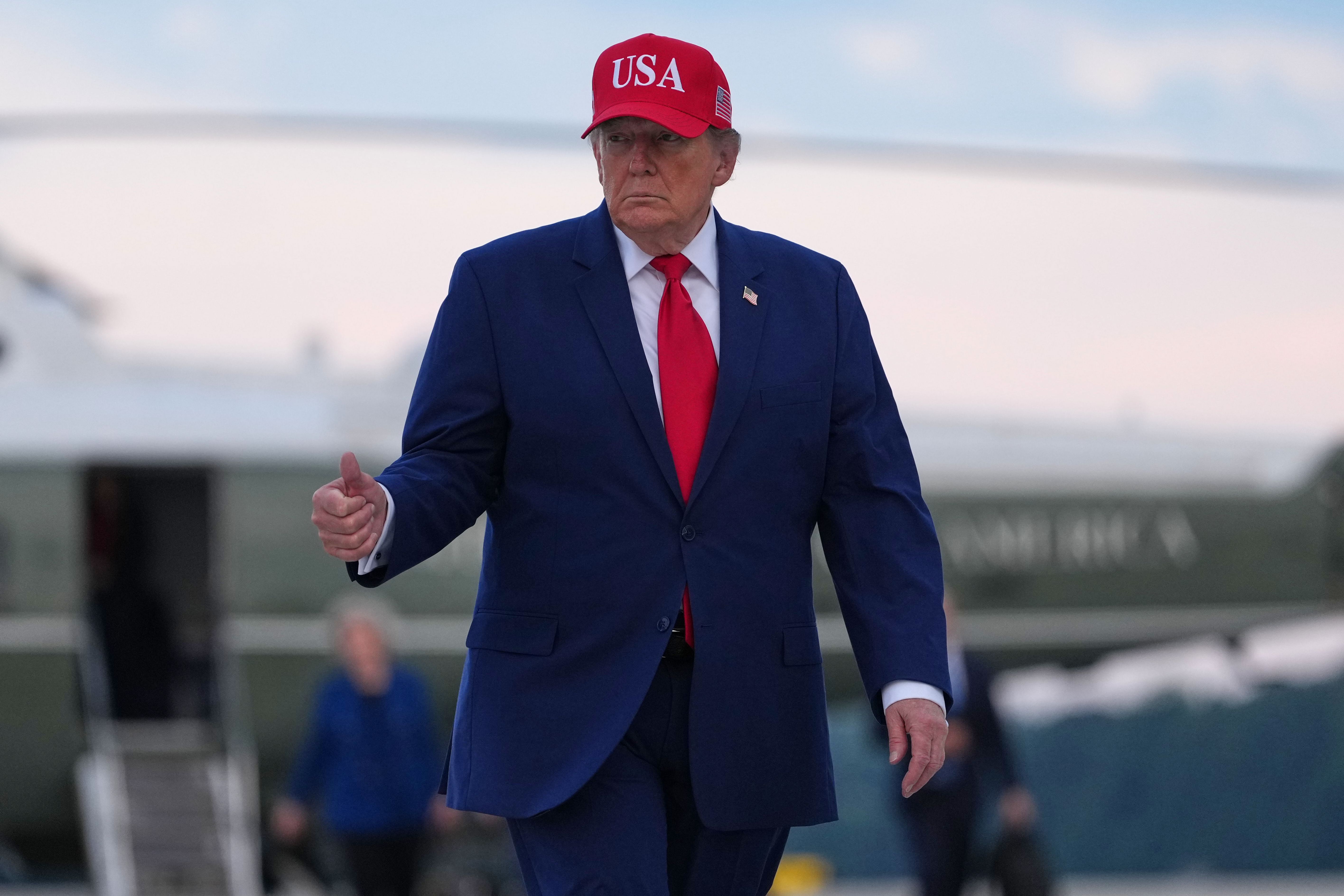 Trump puts new Russia sanctions passed by Congress on hold , saying waiver is in US national interest
