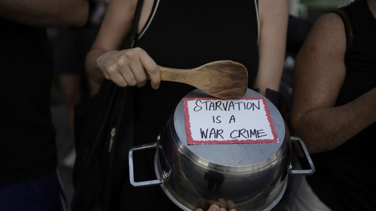 FILE - An Israeli activist bangs a pot with a wooden spoon to protest the starvation of Palestinian civilians in the Gaza Strip, outside the U.S. Embassy branch office in Tel Aviv, Israel, July 24, 2025. (AP Photo/Maya Alleruzzo, File)