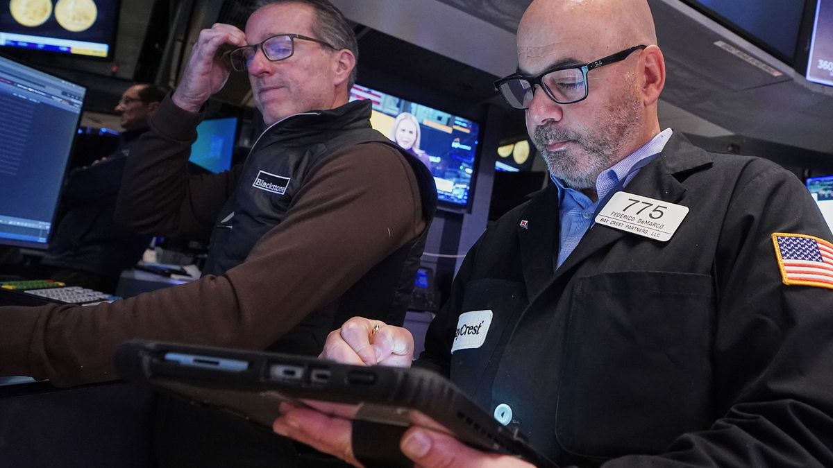 Specialist Glenn Carell, left, and trader Fred Demarco work on the floor of the New York Stock Exchange, Tuesday, Nov. 18, 2025. (AP Photo/Richard Drew)