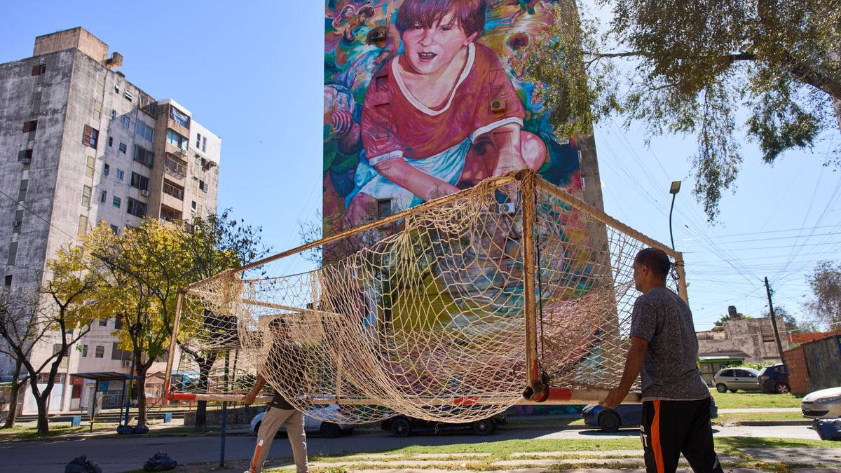 Workers from the Grandoli football club carry a goalpost to the pitch for children's soccer matches in Rosario, Argentina, Saturday, May 2, 2026. (AP Photo/Rodrigo Abd)