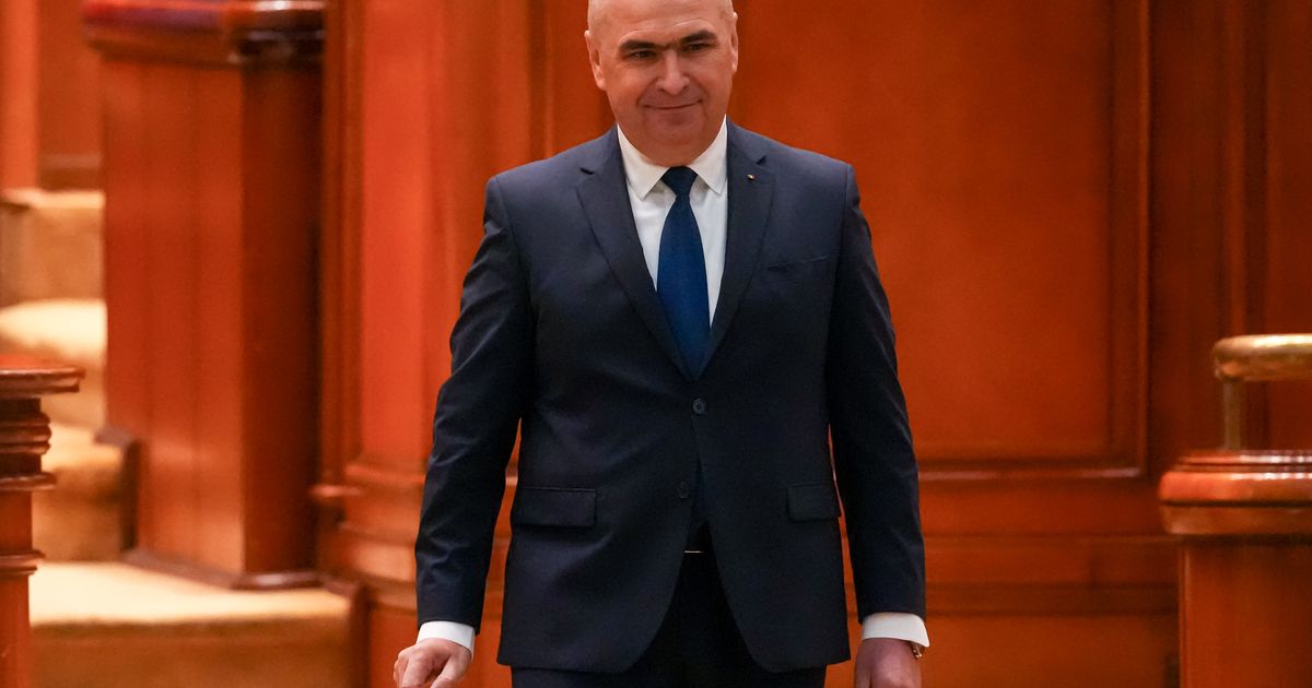 Romania’s prime minister fights for survival as no-confidence motion is debated in Parliament
