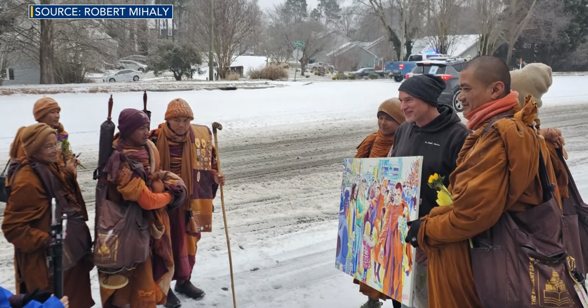 Durham artist gifts Walk For Peace monks painting as they leave Raleigh