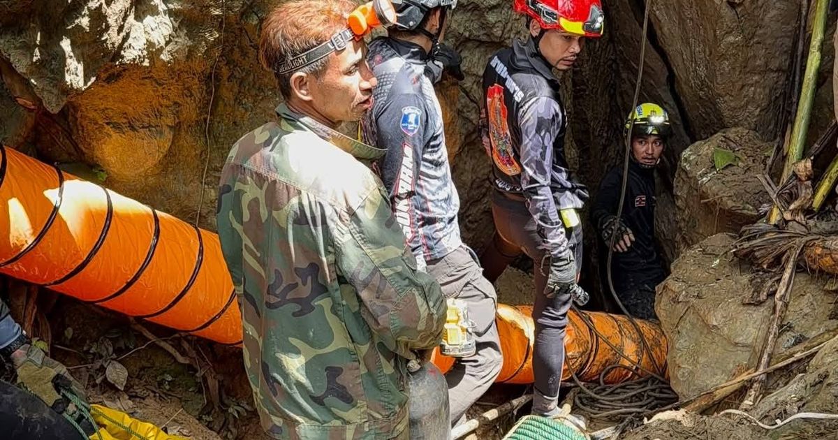 Rescuers race to reach 7 trapped in a Laos cave after flash floods block exit