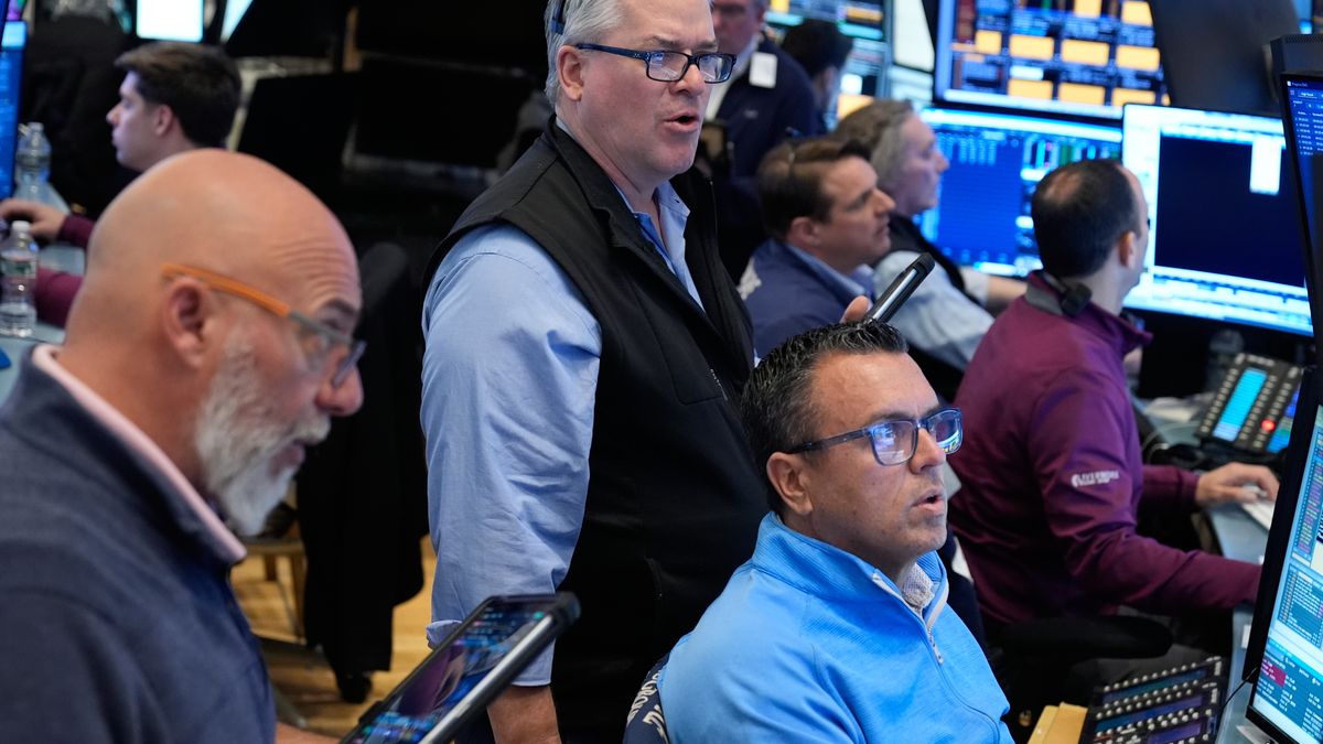People work on the floor at the New York Stock Exchange in New York, Monday, March 30, 2026. (AP Photo/Seth Wenig)