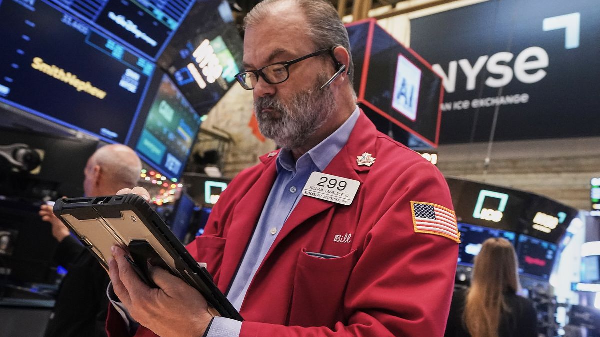 Trader William Lawrence works on the floor of the New York Stock Exchange, Thursday, Dec. 11, 2025. (AP Photo/Richard Drew)