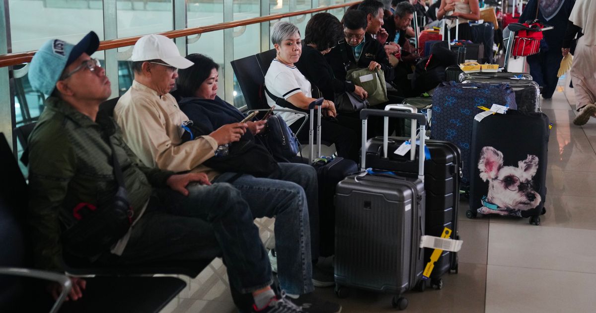 Travelers wait for their flights at Soekarno-Hatta International Airport in Tangerang, Indonesia, Sunday, Sept. 6, 2026. (AP