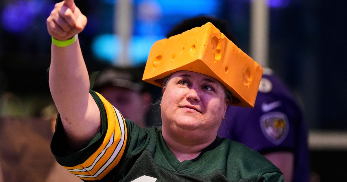 The cheesehead hat is a sunny nod to America's 'Hold my beer' exuberance
