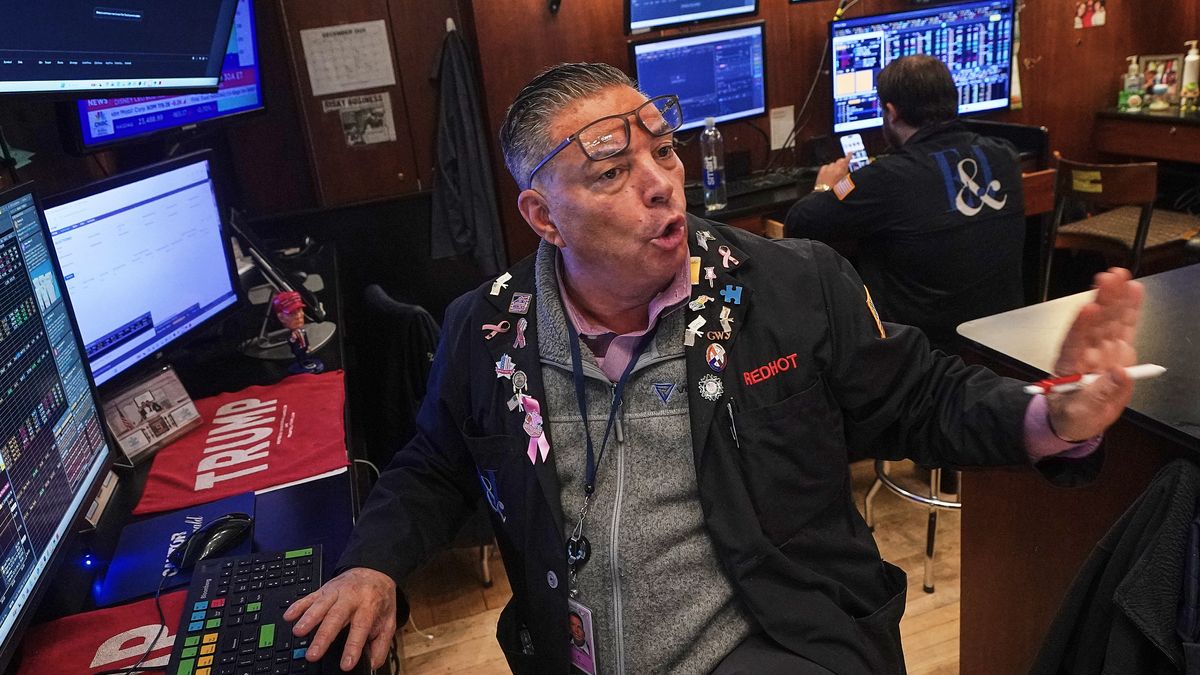 Trader Jonathan Mueller works on the floor of the New York Stock Exchange, Thursday, Dec. 11, 2025. (AP Photo/Richard Drew)
