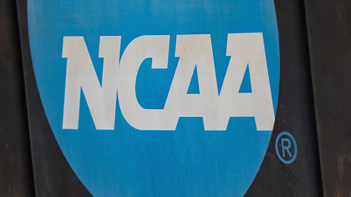 FILE - NCAA logo displayed on the fence before an NCAA softball game between Jacksonville and FGCU, March 24, 2024, in Jacksonville, Fla. (AP Photo/Gary McCullough, File)