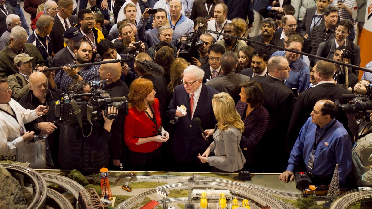 FILE - Berkshire Hathaway Chairman and CEO Warren Buffett, center, is surrounded by journalists and shareholders as he stops by a model railroad while touring the exhibit floor where Berkshire subsidiaries display their products in Omaha, Neb., April 30, 2011, prior to presiding over the annual Berkshire Hathaway shareholders meeting. (AP Photo/Nati Harnik, File)