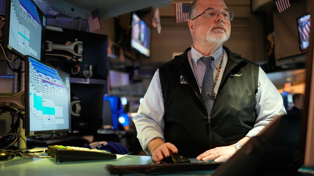 Douglas Johnson works on the floor at the New York Stock Exchange in New York, Thursday, Feb. 12, 2026. (AP Photo/Seth Wenig)