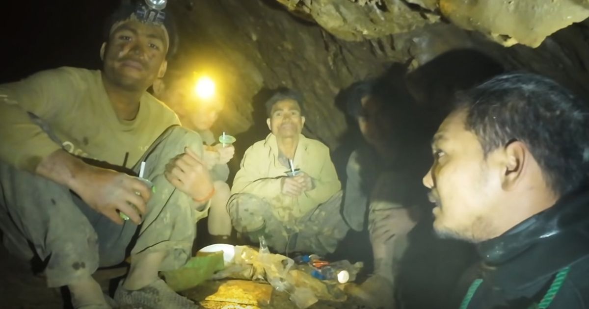 Rescuers free 4 men who had been trapped in a flooded Laos cave, search for 2 still missing