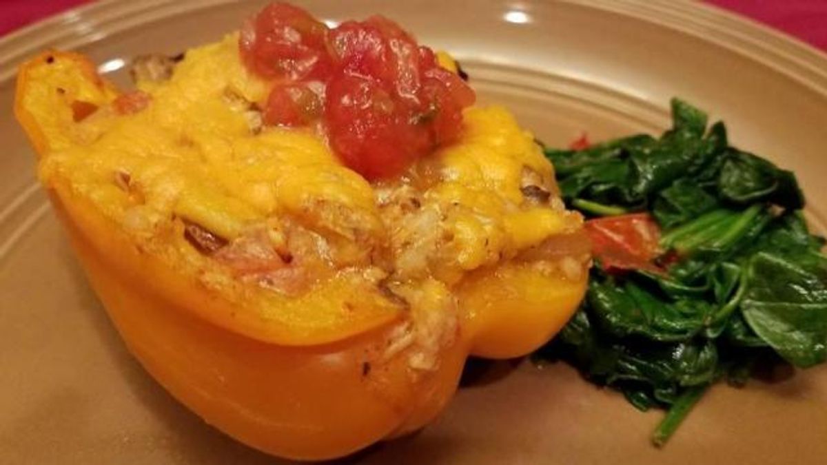 Stuffed yellow pepper and sauteed garlic spinach