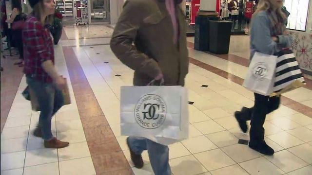 Last-minute shoppers scurry through malls in search of Christmas gifts