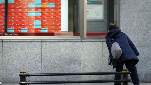 FILE - A person looks at an electronic stock board showing Japan's Nikkei 225 index at a securities firm in Tokyo, on Jan. 17, 2024. Asian shares were mixed on Monday, Feb. 12, with most regional markets closed for holidays, and U.S. futures edged lower after the S&P 500 ended last week above 5,000. (AP Photo/Eugene Hoshiko, File) FILE - A person looks at an electronic stock board showing Japan's Nikkei 225 index at a securities firm in Tokyo, on Jan. 17, 2024. Asian shares were mixed on Monday, Feb. 12, with most regional markets closed for holidays, and U.S. futures edged lower after the S&P 500 ended last week above 5,000. (AP Photo/Eugene Hoshiko, File)