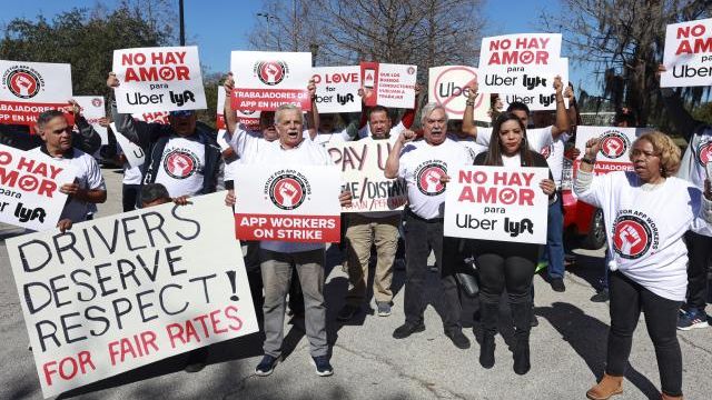 Ride-share drivers protest near Orlando International Airport at Airport Lakes Park, Wednesday, Feb. 14, 2024, in Orlando, Fla. Thousands of ride-hailing and delivery workers in the U.S. and the U.K. went on strike on Valentine's Day, calling for higher pay and other changes to their working conditions. (Joe Burbank/Orlando Sentinel via AP) Ride-share drivers protest near Orlando International Airport at Airport Lakes Park, Wednesday, Feb. 14, 2024, in Orlando, Fla. Thousands of ride-hailing and delivery workers in the U.S. and the U.K. went on strike on Valentine's Day, calling for higher pay and other changes to their working conditions. (Joe Burbank/Orlando Sentinel via AP)