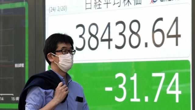 A person walks in front of an electronic stock board showing Japan's Nikkei index at a securities firm Tuesday, Feb. 20, 2024, in Tokyo. Asian shares were trading mixed Tuesday a day after Chinese markets reopened from a long Lunar New Year holiday. (AP Photo/Eugene Hoshiko) A person walks in front of an electronic stock board showing Japan's Nikkei index at a securities firm Tuesday, Feb. 20, 2024, in Tokyo. Asian shares were trading mixed Tuesday a day after Chinese markets reopened from a long Lunar New Year holiday. (AP Photo/Eugene Hoshiko)