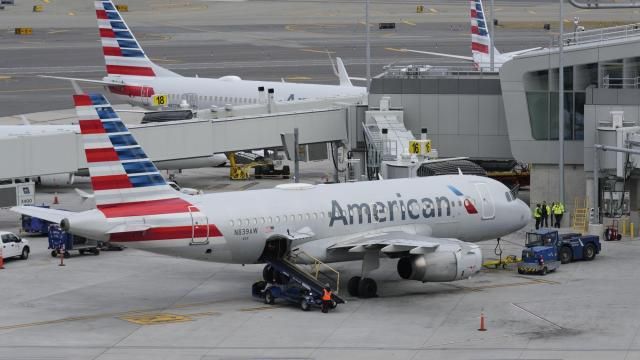 FILE - American Airlines planes sit on the tarmac at Terminal B at LaGuardia Airport, Jan. 11, 2023, in New York. American Airlines is raising bag fees and pushing customers to buy tickets directly from the airline if they want to earn frequent-flyer points. American said Tuesday, Feb. 20, 2024, that checking a bag on domestic flights will rise from $30 now to $35 online, and it'll be $40 if purchased at the airport. (AP Photo/Seth Wenig, File) FILE - American Airlines planes sit on the tarmac at Terminal B at LaGuardia Airport, Jan. 11, 2023, in New York. American Airlines is raising bag fees and pushing customers to buy tickets directly from the airline if they want to earn frequent-flyer points. American said Tuesday, Feb. 20, 2024, that checking a bag on domestic flights will rise from $30 now to $35 online, and it'll be $40 if purchased at the airport. (AP Photo/Seth Wenig, File)