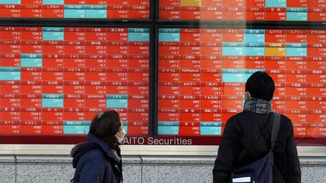 FILE - People look at an electronic stock board showing Japan's stock prices at a securities firm in Tokyo, on Jan. 17, 2024. Asian stocks were mixed Wednesday, Feb. 21, 2024 after technology stocks led Wall Street broadly lower on Tuesday, with investors waiting for chipmaker Nvidia's quarter earning report. (AP Photo/Eugene Hoshiko, File) FILE - People look at an electronic stock board showing Japan's stock prices at a securities firm in Tokyo, on Jan. 17, 2024. Asian stocks were mixed Wednesday, Feb. 21, 2024 after technology stocks led Wall Street broadly lower on Tuesday, with investors waiting for chipmaker Nvidia's quarter earning report. (AP Photo/Eugene Hoshiko, File)