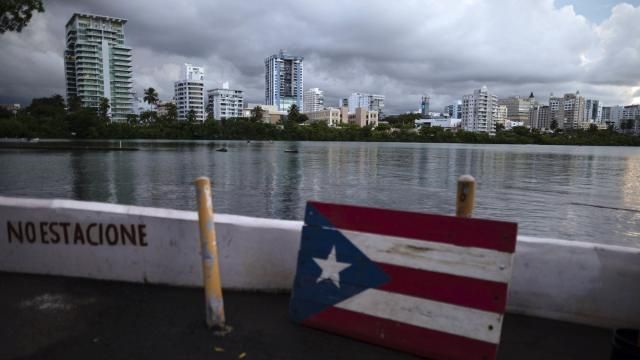FILE - A wooden Puerto Rican flag is displayed on the dock of the Condado lagoon in San Juan, Puerto Rico, Sept. 30, 2021. The U.S. territory is seeing a growing number of displaced renters and a spike in housing costs, according to a Feb. 21, 2024 report by the Hispanic Federation. (AP Photo/Carlos Giusti, File) FILE - A wooden Puerto Rican flag is displayed on the dock of the Condado lagoon in San Juan, Puerto Rico, Sept. 30, 2021. The U.S. territory is seeing a growing number of displaced renters and a spike in housing costs, according to a Feb. 21, 2024 report by the Hispanic Federation. (AP Photo/Carlos Giusti, File)