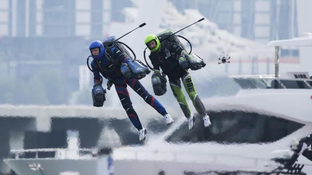 Jet suit pilots race in Dubai, United Arab Emirates, Wednesday, Feb. 28, 2024. Dubai on Wednesday hosted what it called its first-ever jet suit race. Racers zipped along a route with the skyscrapers of Dubai Marina looming behind them, controlling the jet engines on their hands and their backs. (AP Photo/Jon Gambrell)