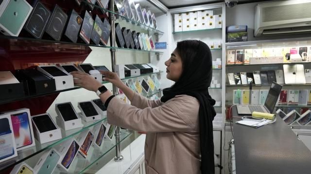 A cellphone vendor works at her shop in downtown Tehran, Iran, Wednesday, Feb. 21, 2024. Even though Supreme Leader Ayatollah Ali Khamenei has denounced American luxury goods amid years of tensions with the West, consumers still want the phones and the prestige associated with them. (AP Photo/Vahid Salemi) A cellphone vendor works at her shop in downtown Tehran, Iran, Wednesday, Feb. 21, 2024. Even though Supreme Leader Ayatollah Ali Khamenei has denounced American luxury goods amid years of tensions with the West, consumers still want the phones and the prestige associated with them. (AP Photo/Vahid Salemi)