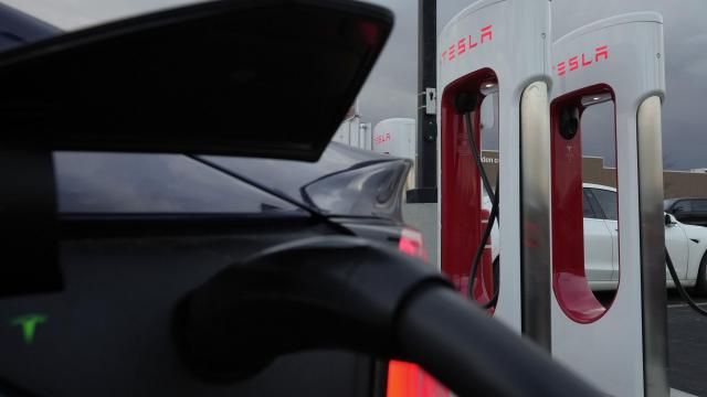 FILE - A vehicle charges at a Tesla Supercharger station in Detroit, Nov. 16, 2022. Owners of Ford electric vehicles can now use much of Tesla's charging network in the U.S. and Canada, but there's a hitch: they'll need to get an adapter that Ford will provide for free, although the company won't start shipping those until the end of March 2024. (AP Photo/Paul Sancya, File) FILE - A vehicle charges at a Tesla Supercharger station in Detroit, Nov. 16, 2022. Owners of Ford electric vehicles can now use much of Tesla's charging network in the U.S. and Canada, but there's a hitch: they'll need to get an adapter that Ford will provide for free, although the company won't start shipping those until the end of March 2024. (AP Photo/Paul Sancya, File)
