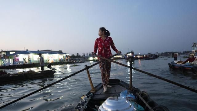 Nguyen Thi Thuy, a vendor who sells steamed buns on a floating market, paddles her boat in Can Tho, Vietnam, Wednesday, Jan. 17, 2024. On good days she makes about $4 — hardly enough to put food on the table. (AP Photo/Jae C. Hong) Nguyen Thi Thuy, a vendor who sells steamed buns on a floating market, paddles her boat in Can Tho, Vietnam, Wednesday, Jan. 17, 2024. On good days she makes about $4 — hardly enough to put food on the table. (AP Photo/Jae C. Hong)