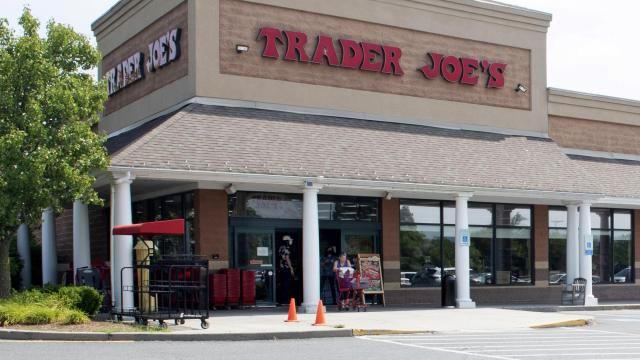 FILE - A shopper pushes a cart from the Trader Joe's supermarket on July 28, 2022, in Hadley, Mass. Trader Joe's mini canvas tote is the latest item to cause a stir on social media, so much so that resellers are taking advantage of the hype. (Carol Lollis/The Daily Hampshire Gazette via AP, File) FILE - A shopper pushes a cart from the Trader Joe's supermarket on July 28, 2022, in Hadley, Mass. Trader Joe's mini canvas tote is the latest item to cause a stir on social media, so much so that resellers are taking advantage of the hype. (Carol Lollis/The Daily Hampshire Gazette via AP, File)