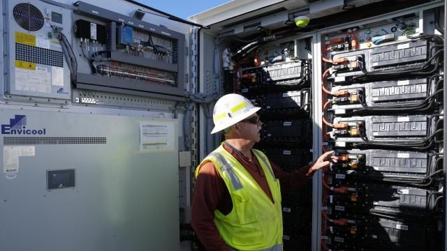 Mike Vandrely, construction manager, checks on a battery storage pod at Orsted's Eleven Mile Solar Center lithium-ion battery storage energy facility Thursday, Feb. 29, 2024, in Coolidge, Ariz. Batteries allow renewables to replace fossil fuels like oil, gas and coal, while keeping a steady flow of power when sources like wind and solar are not producing. (AP Photo/Ross D. Franklin) Mike Vandrely, construction manager, checks on a battery storage pod at Orsted's Eleven Mile Solar Center lithium-ion battery storage energy facility Thursday, Feb. 29, 2024, in Coolidge, Ariz. Batteries allow renewables to replace fossil fuels like oil, gas and coal, while keeping a steady flow of power when sources like wind and solar are not producing. (AP Photo/Ross D. Franklin)