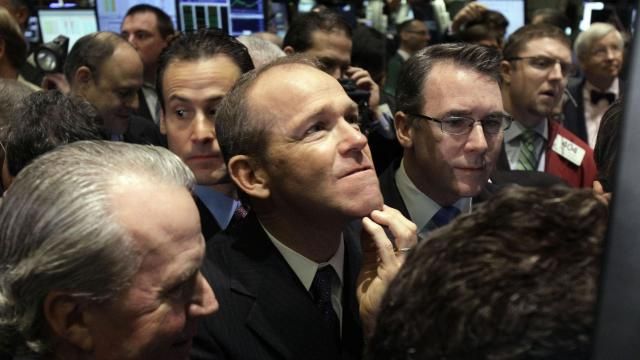 FILE - Then-Nielsen Company CEO David Calhoun, center, watches progress as he waits for the company's IPO to begin trading, Jan. 26, 2011, on the floor of the New York Stock Exchange. Calhoun will be stepping down at the end of the year from the top job at Boeing, which is under pressure from major airlines wanting to know how the company plans to fix problems in the manufacturing of its planes. (AP Photo/Richard Drew, File) FILE - Then-Nielsen Company CEO David Calhoun, center, watches progress as he waits for the company's IPO to begin trading, Jan. 26, 2011, on the floor of the New York Stock Exchange. Calhoun will be stepping down at the end of the year from the top job at Boeing, which is under pressure from major airlines wanting to know how the company plans to fix problems in the manufacturing of its planes. (AP Photo/Richard Drew, File)