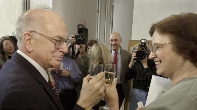 FILE - Psychology professor Daniel Kahneman, left, a U.S. and Israeli citizen based at Princeton University, and his wife Anne Treisman, also a psychology professor at the university, have champagne following a news conference at the school in Princeton, N.J., to give his reaction to winning the Nobel prize in economics, Oct. 9, 2002. Kahneman died Wednesday, March 27, 2024, at the age of 90. (AP Photo/Daniel Hulshizer, File) FILE - Psychology professor Daniel Kahneman, left, a U.S. and Israeli citizen based at Princeton University, and his wife Anne Treisman, also a psychology professor at the university, have champagne following a news conference at the school in Princeton, N.J., to give his reaction to winning the Nobel prize in economics, Oct. 9, 2002. Kahneman died Wednesday, March 27, 2024, at the age of 90. (AP Photo/Daniel Hulshizer, File)