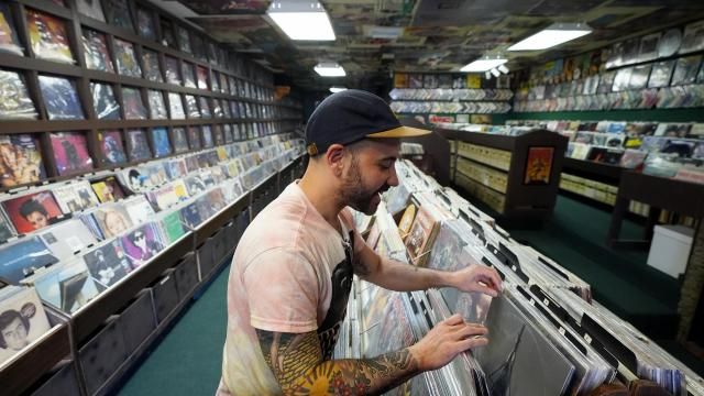 Jeff Maimon, of Chicago, checks out some vinyl at Tracks In Wax record shop, Thursday, April 18, 2024, in Phoenix. Special LP releases, live performances and at least one giant block party are scheduled around the U.S. Saturday as hundreds of shops celebrate Record Store Day amid a surge of interest in vinyl and the day after the release of Taylor Swift's latest album. (AP Photo/Ross D. Franklin) Jeff Maimon, of Chicago, checks out some vinyl at Tracks In Wax record shop, Thursday, April 18, 2024, in Phoenix. Special LP releases, live performances and at least one giant block party are scheduled around the U.S. Saturday as hundreds of shops celebrate Record Store Day amid a surge of interest in vinyl and the day after the release of Taylor Swift's latest album. (AP Photo/Ross D. Franklin)