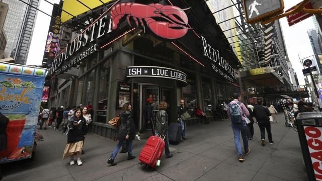 **This image is for use with this specific article only** People walk past a Red Lobster seafood restaurant in Times Square, New York, on May 15. Mandatory Credit: Anthony Behar/SIPPL Sipa USA/AP via CNN Newsource.