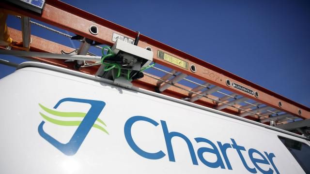 FILE - This April 1, 2015, file photo, shows a Charter Communications van in St. Louis. (AP Photo/Jeff Roberson, File)