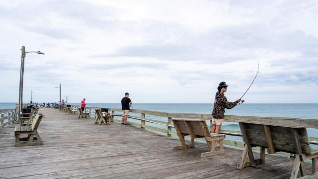 Anglers at the fishing pier in Nags Head, N.C., in May 2025. On the Outer Banks, a chain of barrier islands off North Carolina, businesses are trying to adapt to the current economy. (Daniel Pullen/The New York Times)