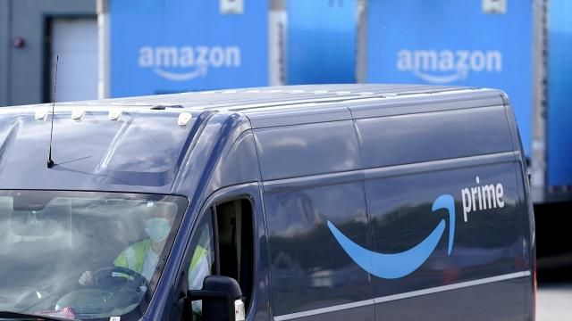 FILE - An Amazon Prime logo appears on the side of a delivery van as it departs an Amazon Warehouse location in Dedham, Mass., Oct. 1, 2020. (AP Photo/Steven Senne, File)