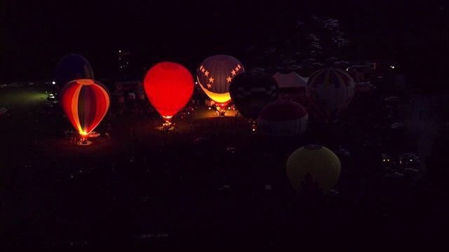 Balloon glow lights up night sky