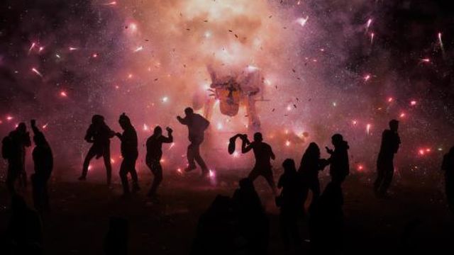 People dance and dodge a giant paper-mache bull stuffed with fireworks as roman candles and bottle rockets shower them with sparks, during the annual festival honoring Saint John of God, in Tultepec, Mexico, Friday, March 8, 2024. The celebration, now its 35th year, pays homage to the patron saint of the poor and sick, St. John of God, who the fireworks' producers view as a protective figure. (AP Photo/Marco Ugarte) People dance and dodge a giant paper-mache bull stuffed with fireworks as roman candles and bottle rockets shower them with sparks, during the annual festival honoring Saint John of God, in Tultepec, Mexico, Friday, March 8, 2024. The celebration, now its 35th year, pays homage to the patron saint of the poor and sick, St. John of God, who the fireworks' producers view as a protective figure. (AP Photo/Marco Ugarte)