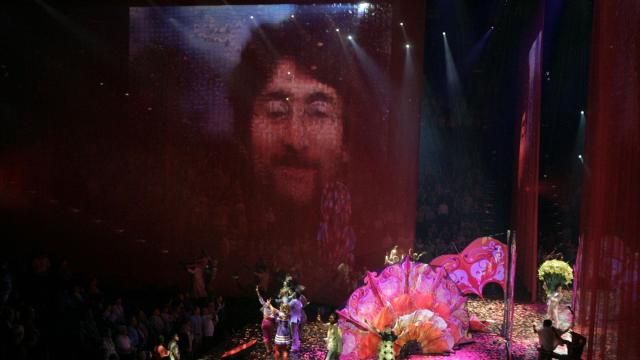 FILE - A photo of Beatles member John Lennon is projected on the screen during the preview of "Love," a new Beatles-themed Cirque du Soleil show, in Las Vegas, June 27, 2006. On Tuesday, April 9, 2024, it was announced that the final curtain will come down July 7 on Cirque du Soleil's long-running show “The Beatles Love," a cultural icon on the Las Vegas Strip that brought band members Paul McCartney and Ringo Starr back together for public appearances throughout its 18-year run. (AP Photo/Jae C. Hong, File)