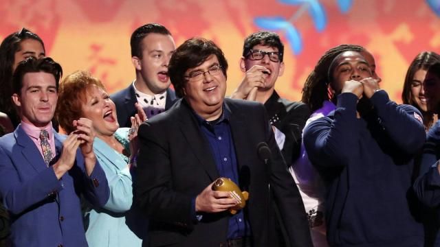 FILE - Dan Schneider, center, accepts an award in Los Angeles. Schneider sued the makers of “Quiet on Set: The Dark Side of Kids TV” on Wednesday, May 1, 2024, alleging the makers of the documentary series wrongly implied that he sexually abused the child actors he worked with. (Photo by Matt Sayles/Invision/AP, File)