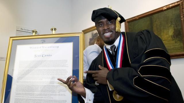 FILE - Entertainer and entrepreneur Sean Combs poses next to his honorary degree of Doctor of Humanities during the graduation ceremony at Howard University in Washington, Saturday, May 10, 2014. In a decision, Friday, June 7, 2024, Howard University is cutting ties to Combs, rescinding the honorary degree that was awarded to him and disbanding a scholarship program in his name. (AP Photo/Jose Luis Magana, File)