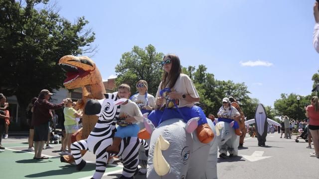 Crowds dressed in inflatable costumes participate in the 'Rhino Rumble Road Race' to celebrate the 30th anniversary of the film 'Jumanji' in downtown Keene, N.H. on Saturday, June 21, 2025. (AP Photo/Leah Willingham)