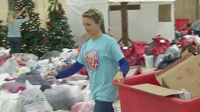 Volunteers sort, deliver gifts to needy families