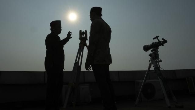 FILE - Officials are silhouetted as they use a telescope to scan the horizon for a crescent moon that will determine the beginning of the holy fasting month of Ramadan in Jakarta, Indonesia, Wednesday, March. 22, 2023. (AP Photo/Achmad Ibrahim, File) FILE - Officials are silhouetted as they use a telescope to scan the horizon for a crescent moon that will determine the beginning of the holy fasting month of Ramadan in Jakarta, Indonesia, Wednesday, March. 22, 2023. (AP Photo/Achmad Ibrahim, File)